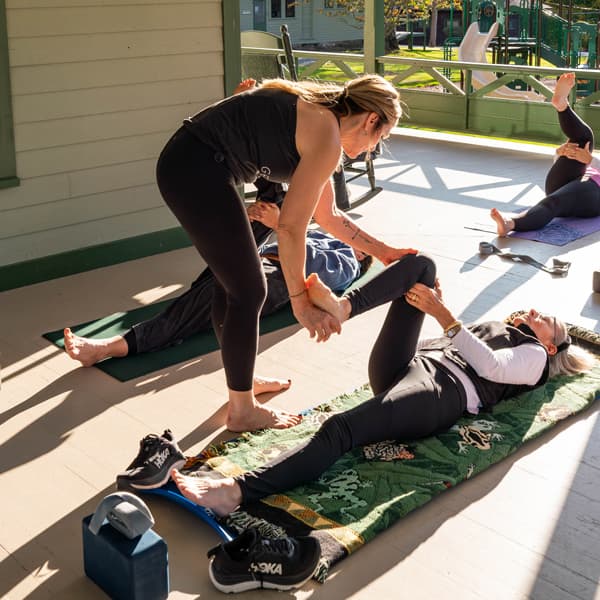 Women stretching together during a Get Flexy wellness retreat